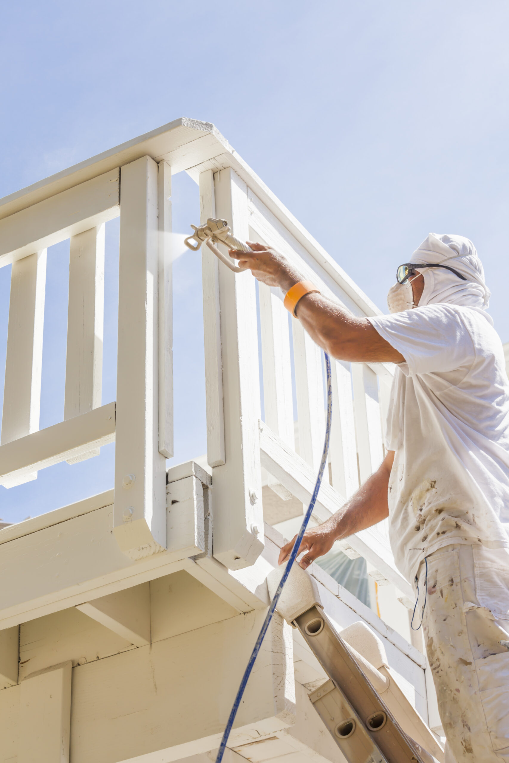 house painter spray painting a deck of a home 2024 09 11 10 45 55 utc scaled
